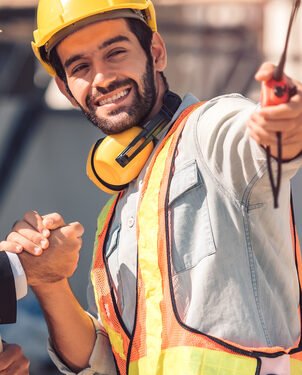 Happy workers at construction site, young civil engineer manager and architects handshaking at construction site and looking to next construction phase  , cooperation teamwork concept.